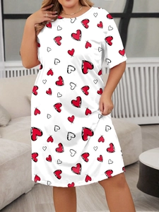 Detail of plus size white T-shirt dress featuring red heart patterns and short sleeves