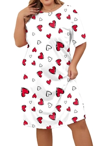 Detail of plus-size white dress with red heart graffiti pattern and round neckline