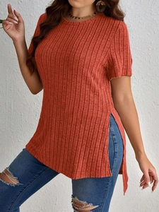 Detail view of ribbed knit rust orange short sleeve top with stylish high side split hem