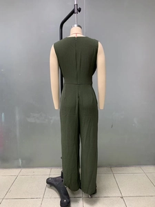 Detail view of the back of a dark green sleeveless wide-leg jumpsuit with pleated texture