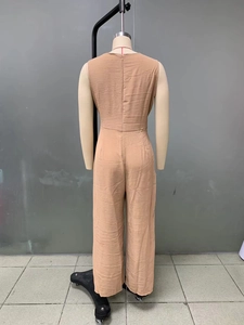 Detail of camel sleeveless wide-leg jumpsuit with textured fabric and back zipper