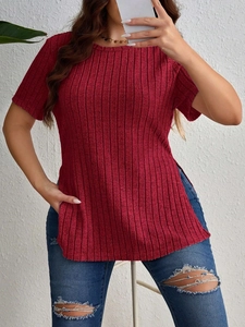 Detail of ribbed knit fabric texture and side slit on a casual crewneck t-shirt