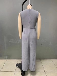 Detail view of the gray textured sleeveless jumpsuit showing the back invisible zipper