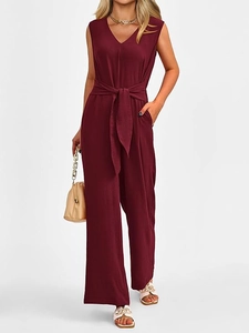 Detail of burgundy V-neck sleeveless jumpsuit with elegant waist tie and wide-leg design