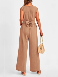 Rear view of brown sleeveless V-neck jumpsuit featuring a large elegant waist bow