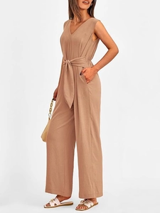 Detail view of coffee-colored V-neck wide-leg jumpsuit with matching waist tie