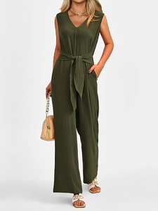 Detail showing elegant V-neckline and waist tie on sleeveless dark olive green jumpsuit