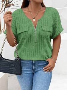 Detail of V-neck ribbed knit top with silver zipper and decorative pockets