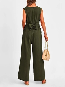 Detail of the back bow-tie belt and textured dark green fabric on wide-leg jumpsuit