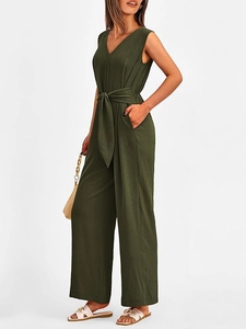 Detailed close-up of an olive green V-neck jumpsuit with a fabric belt and side pockets