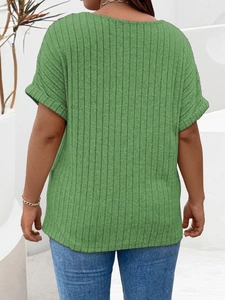 Detail view of green ribbed knit fabric on a loose short sleeve top with rolled cuffs
