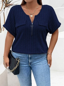 Detailed texture of dark blue ribbed knit fabric with V-neck zipper and faux pockets