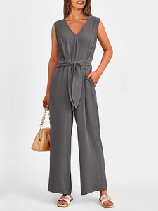Detail of dark grey V-neck sleeveless jumpsuit with waist belt and wide-leg design