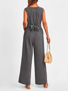Rear view of an elegant grey sleeveless wide-leg jumpsuit with a back bow tie detail