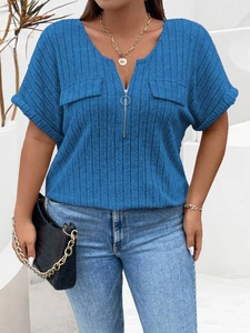 Detail of blue ribbed knit top featuring V-neckline and decorative zipper with round puller