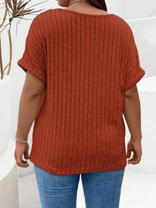 Detail of caramel ribbed knit texture on loose fit women's top with rolled short sleeves