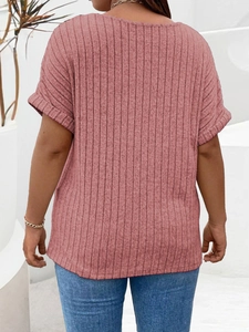 Detailed back view of a pink short-sleeve knit top featuring vertical ribbed texture