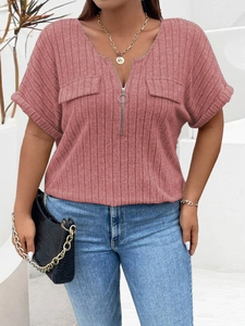 Detail of pink V-neck ribbed top featuring a silver ring zipper and faux pocket flaps
