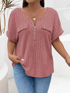 Detail of V-neck ribbed knit top with ring zipper and decorative chest pockets in dusty rose