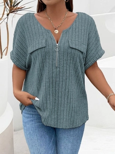 Detail of grey-blue v-neck top featuring a zipper with ring puller and ribbed knit texture