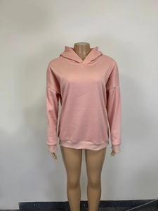 Detailed front view of pink oversized drawstring-free hoodie with ribbed cuffs and hem
