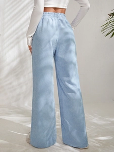 Detail view of light blue corduroy pants with high elastic waist and wide leg cut