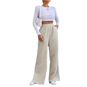 Detail of high waist elastic waistband and corduroy fabric texture on beige wide-leg pants