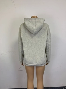 Back view of light grey oversized hoodie featuring drop shoulders and ribbed cuffs