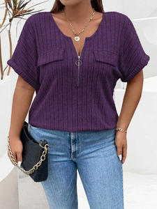 Detail of the V-neckline with silver ring zipper and ribbed fabric texture on purple top