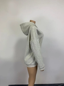 Side view of light grey oversized hoodie showing drop shoulder and ribbed cuff details
