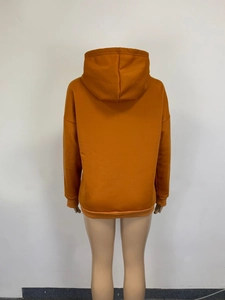 Rear view detail of orange hoodie showing drawstring hood and ribbed cuffs and hem