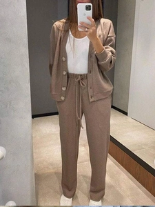 Detail of coffee brown knit tracksuit featuring V-neck cardigan and drawstring pants