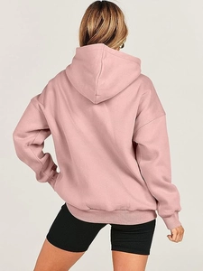 Back view of a pink oversized drawstring hoodie with dropped shoulders and ribbed cuffs