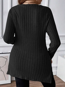 Detail of black rib-knit long sleeve top featuring side slit and slim fit silhouette