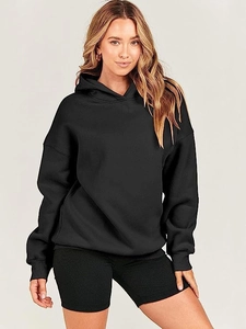 Detail view of oversized black hoodie with ribbed cuffs and dropped shoulder seams