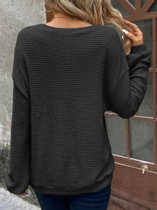 Detailed waffle knit texture on a black drop shoulder long sleeve sweatshirt for women