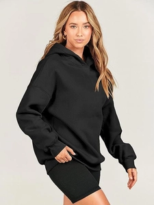 Detail view of oversized black hooded sweatshirt with ribbed biker shorts for women