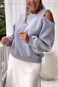 Detail of light grey off-shoulder long sleeve sweatshirt with ribbed cuffs and hem
