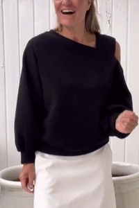 Detail of black off-the-shoulder long sleeve sweatshirt with unique shoulder cutout design