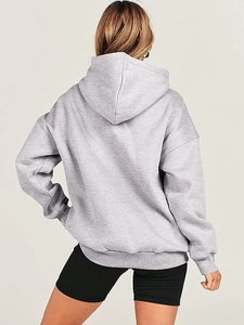 Rear view of an oversized light grey hoodie showing the loose fit and drop shoulder detail