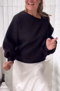 Close-up of black oversized sweatshirt with ribbed cuffs and relaxed loose silhouette