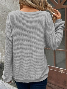 Detail view of grey waffle knit long sleeve top with drop shoulders and casual loose fit