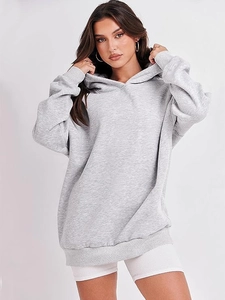 Detail of grey oversized hoodie showing warm cotton blend fabric and loose casual fit
