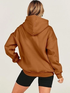 Rear view of oversized caramel hoodie showing fabric texture and drop shoulder design
