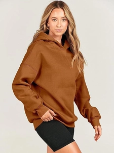 Detailed close-up of oversized caramel brown hoodie with textured ribbed black shorts