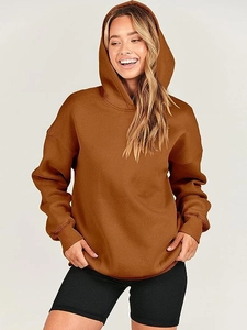 Detailed close-up of dark brown oversized hoodie showing ribbed cuffs and hood texture