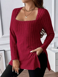 Close-up of dark red ribbed knit top featuring a square neckline and side slit hem detail