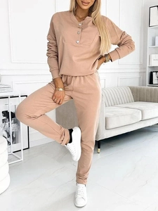 Detailed close-up of a nude knitted two-piece lounge set with decorative buttons