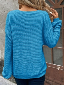 Detailed back view of a blue waffle-knit crewneck sweatshirt with ribbed cuffs for winter