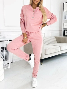 Detail of pink lounge set showing half-button collar and soft ribbed cotton fabric texture